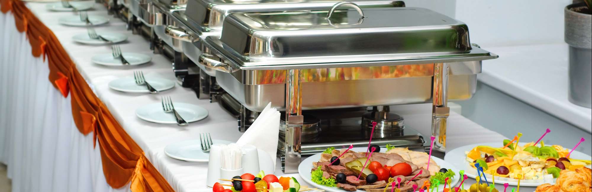 banquet table with chafing dish heaters and canapes