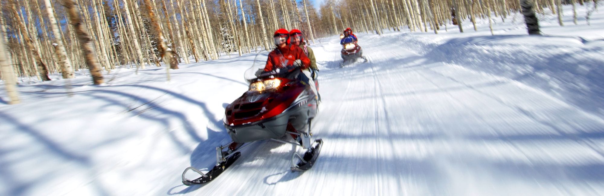 Couples Racing on Snowmobiles