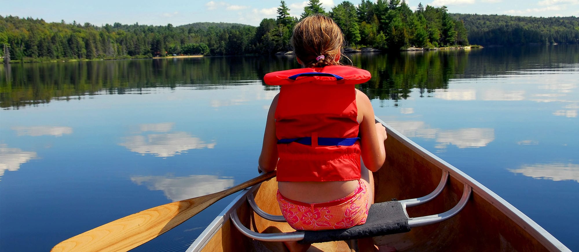 Child in a canoe on the lake