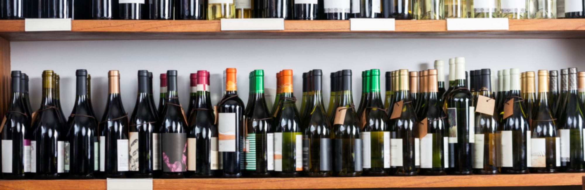 Wine bottles displayed on shelves in supermarket