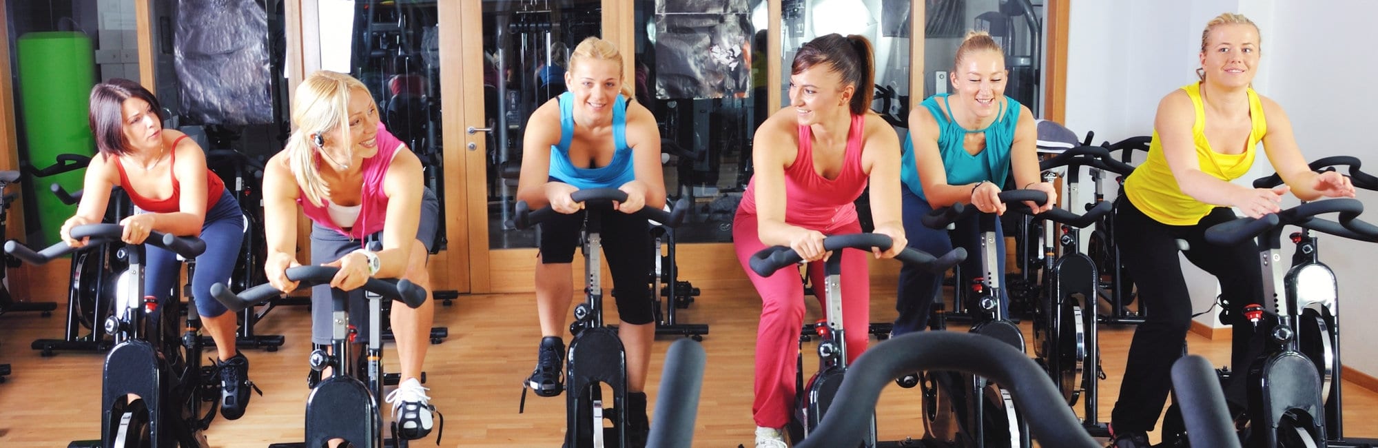 Beautiful women doing exercise in a spinning class at gym