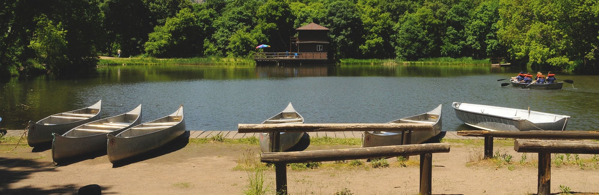 Boats on a pond in the mountains for scout camp